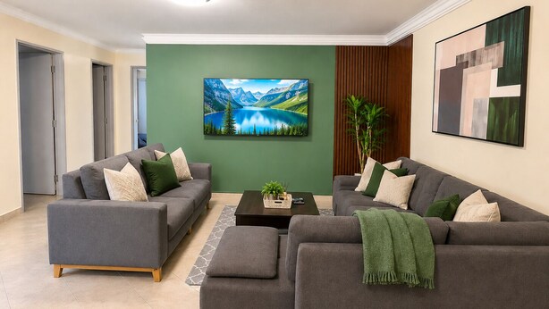 A modern living room with two grey sofas, a coffee table, and a painting of a mountain landscape. - Modern and huge soundproof apt w/AC. Steps to Lleras/Provenza in el Poblado. (Medellín)
