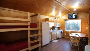 A cabin with bunk beds, a kitchen area, and a dining table. - Alaskan Adventure Dry Cabin #2 (Fairbanks)