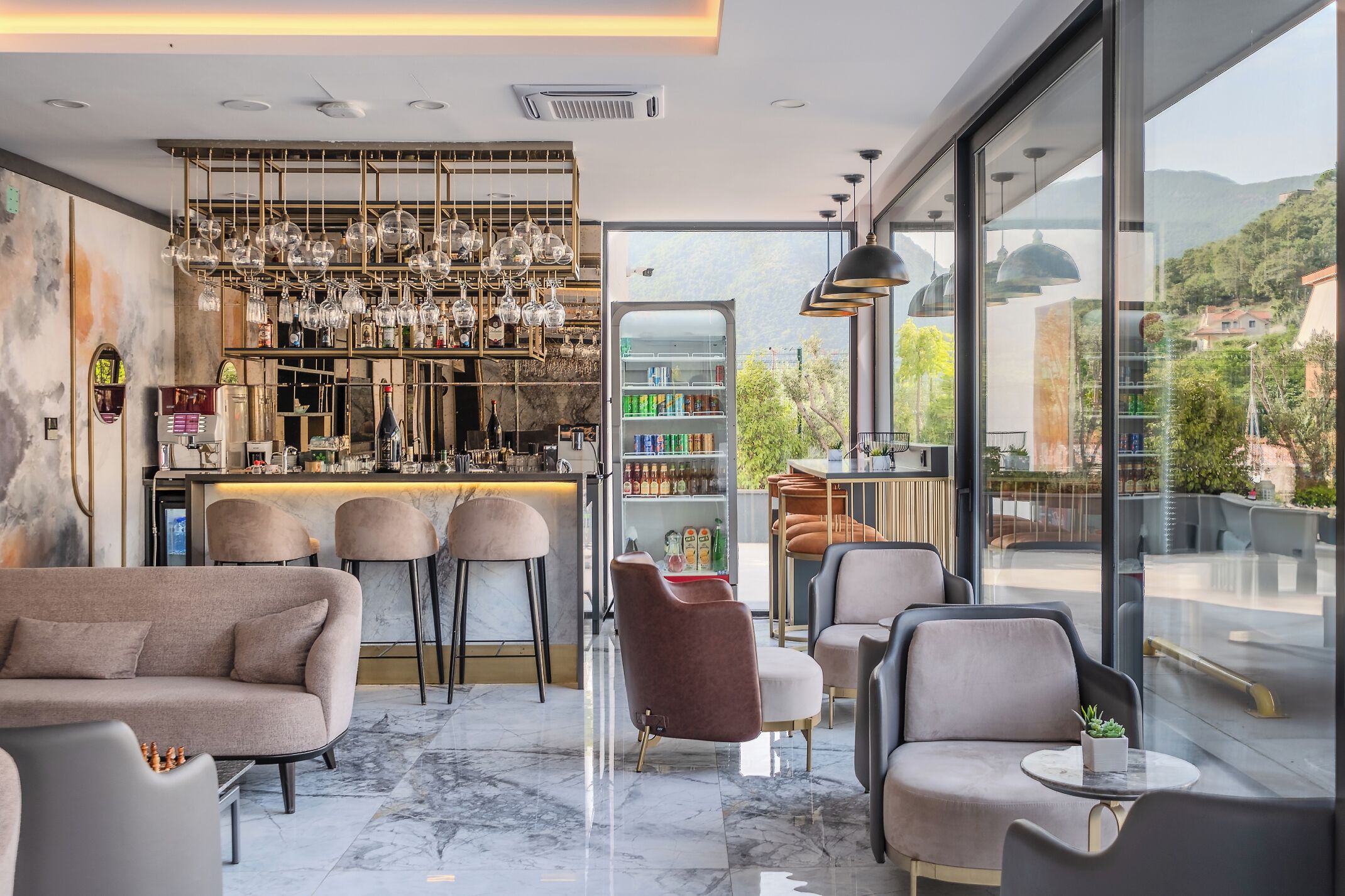 A modern bar area with a wine rack, seating, and a view of the outdoors.