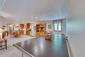 Relax and socialize in this spacious living area, featuring a dining space, kitchenette, and ping pong table.