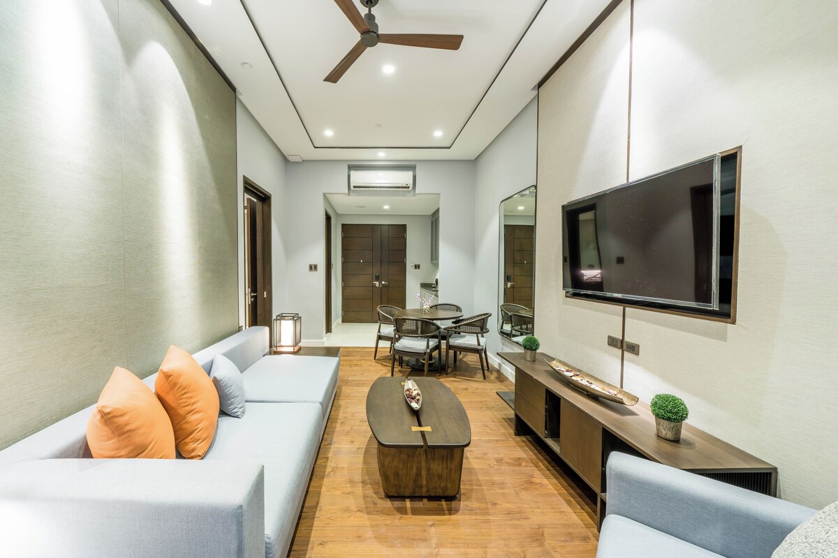 A modern living room with a sofa, coffee table, and TV.