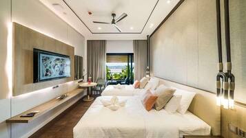A modern hotel room with a large bed, a TV mounted on the wall, a ceiling fan, and a view of the outdoors.