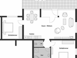 Grundriss eines Hotels mit Wohnzimmer, Küche, Bad und zwei Schlafzimmern.