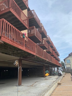 A multi-story building with wooden balconies and a covered parking area. - Waterfront large three bedroom, four bath, townhouse near the beach. (Ocean City)
