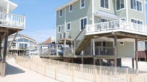 A beachfront property with multiple levels, including a balcony and a covered area. - Beautiful Oceanfront Beach House for the whole family and more (Bethany Beach)