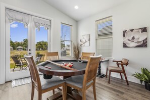 Enjoy a game of pool in this cozy room with a pool table and comfortable seating for four.