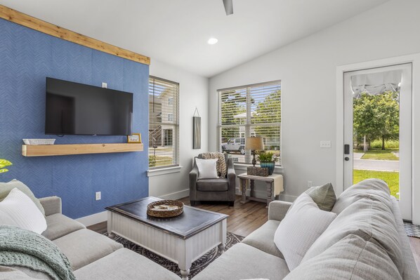 Relax in this stylish living room with a flat-screen TV, comfortable sofa, and a coffee table.