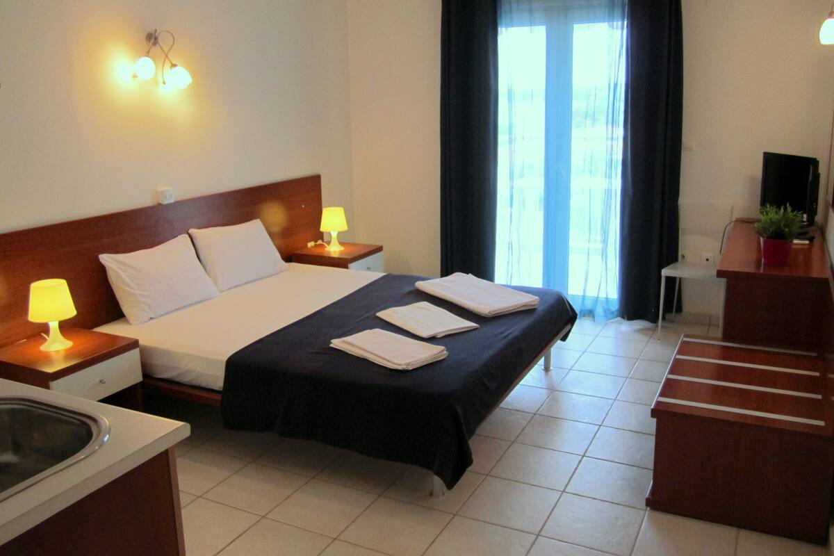 Standard Studio | Premium bedding, desk, laptop workspace, blackout drapes