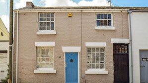 A two-story building with a blue door, white-framed windows, and a 'Yale' sign above the door. - 2 bedroom accommodation in Crosby, near Liverpool (Crosby, near Liverpool)