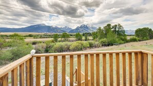A wooden deck with a view of mountains and a cloudy sky. - Montana Vacation Rental: 32 Mi to Yellowstone! (Emigrant)