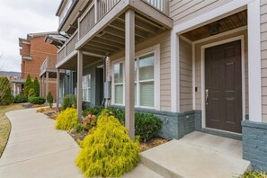 Stunning residential building with balconies and beautifully manicured grounds.