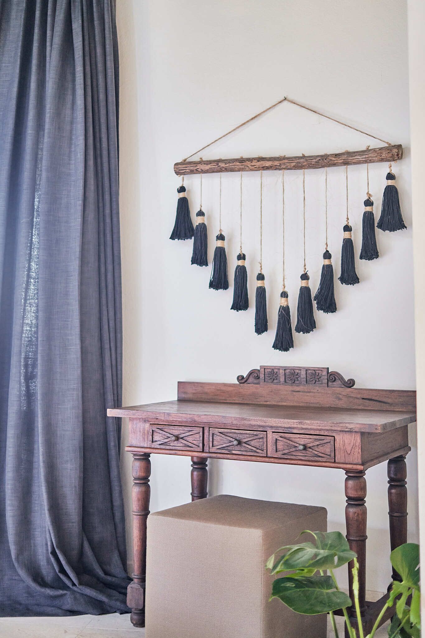 A wooden table with a decorative hanging ornament above it.