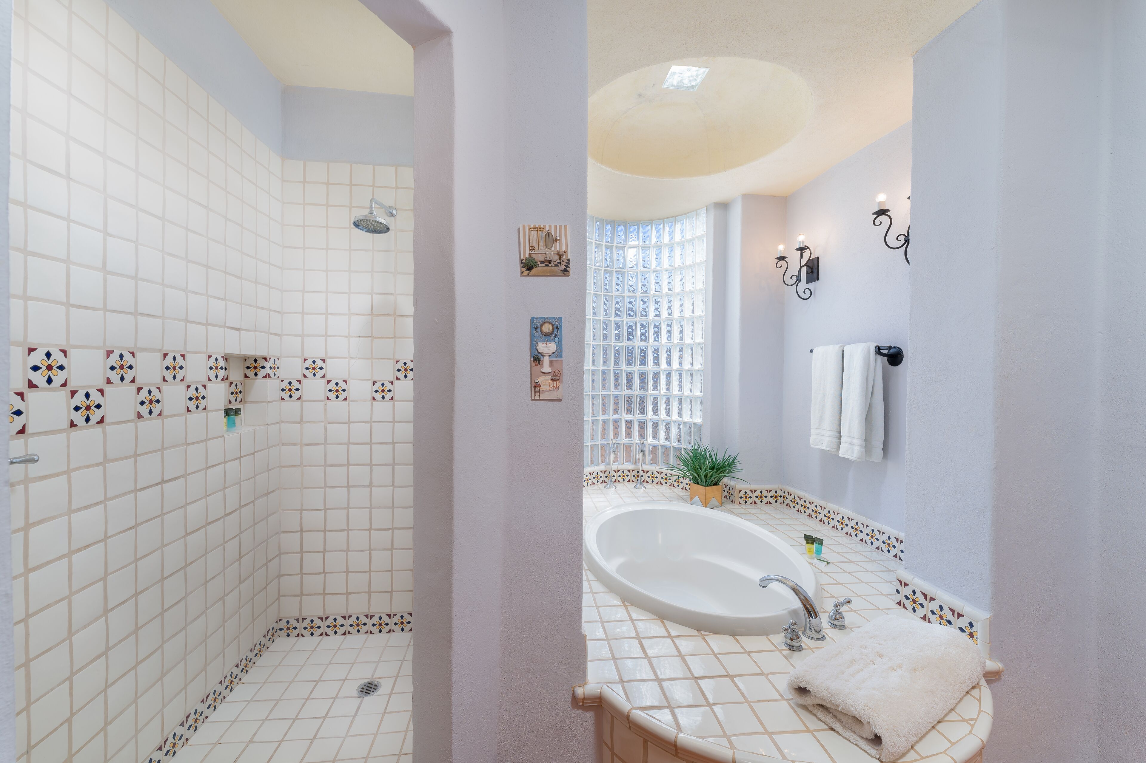 A bathroom with a shower, a bathtub, and a sink.