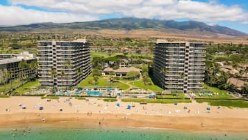 A resort with multiple high-rise buildings, a beach, and a pool area.