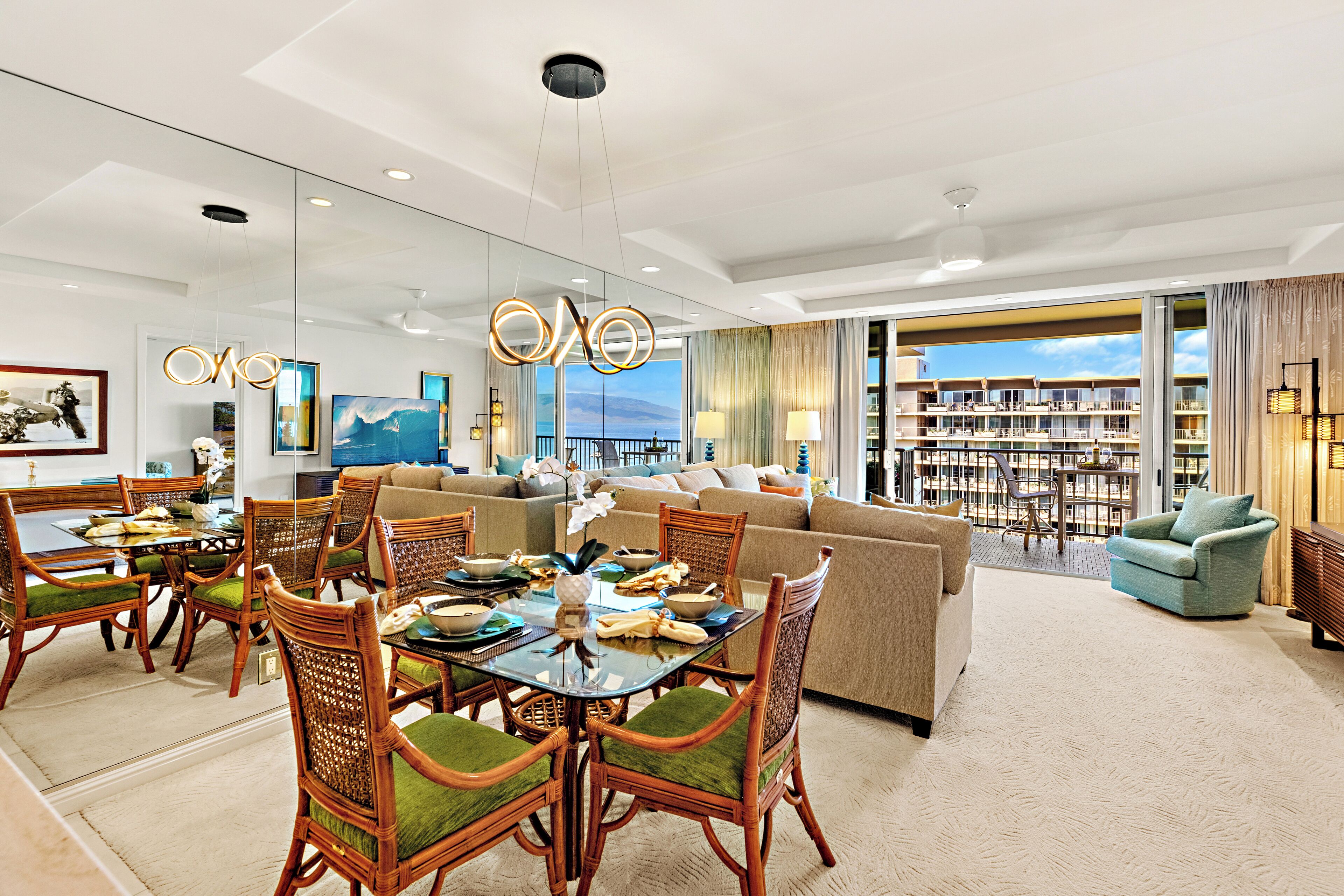 A spacious living area with a dining table, chairs, and a sofa.