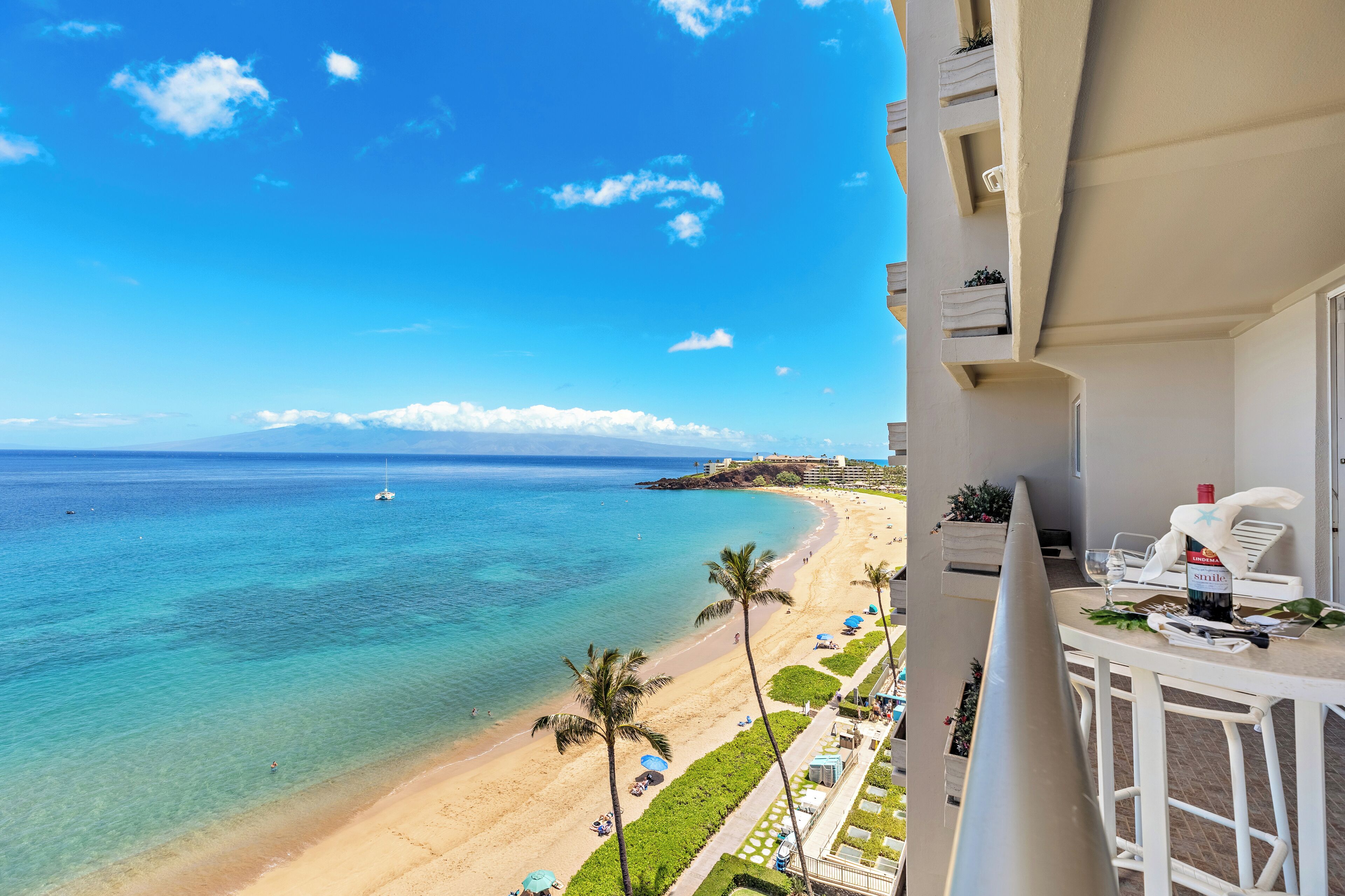 A balcony with a view of a beach and ocean.