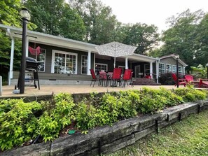 Back deck with BBQ grill, seating, table for six, and views.