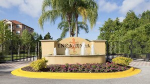 A gated entrance with a sign reading "ENCANTADA" and a fountain.