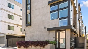 A modern multi-story building with large windows and a flat facade.