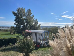 A small, single-story wooden structure with a porch, surrounded by greenery and a clear sky. - Holiday Apartment 'Seezeit Familie Strehl' with Private Garden and Wi-Fi (Frickingen)