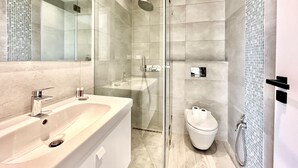 A modern bathroom with a glass-enclosed shower, a large sink, and a toilet. - A12 Stylish and Modern 2bds in La Marsa (La Marsa)