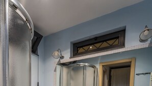 A bathroom with a sink, mirror, toilet, and shower. - b&b Domus Vesuvia (Torre Annunziata)