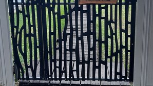 A gated entrance with a sign reading "Churchill Cabin."