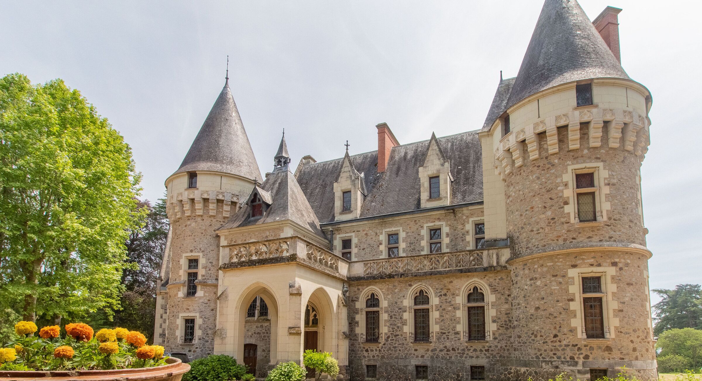 A historic stone castle with multiple towers and arched windows.