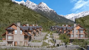 A resort with wooden cabins, a stone pathway, and a backdrop of snow-capped mountains. - Welcomhotel By ITC Hotels Hamsa Manali (Manali)