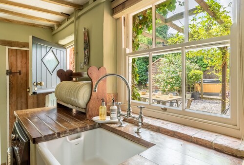A detached and striking, three-storey pink house oozing style and character