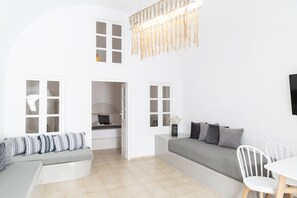 Deluxe Suite | Living area | 45-inch Smart TV with cable channels, TV, Netflix - Captain's House Suites (Santorini)