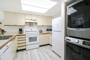Enjoy cooking in this well-equipped kitchen with an oven, microwave, and refrigerator.