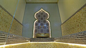 A room with a tiled ceiling and walls, a patterned wall decoration, and a light fixture. - Samaria Hotel and Spa (Samarkand)