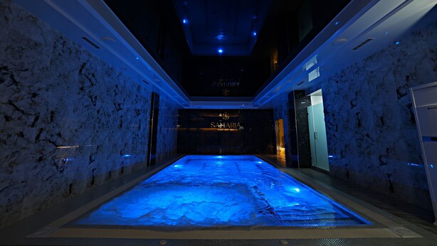 A spa area with a heated floor, marble walls, and a sign reading "Samarina." - Samaria Hotel and Spa (Samarkand)