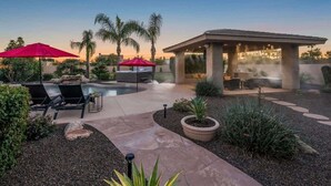 A pool area with lounge chairs, umbrellas, and a hot tub. - Private Mini-Resort w/ Salt water pool & spa- NEW! (Scottsdale)