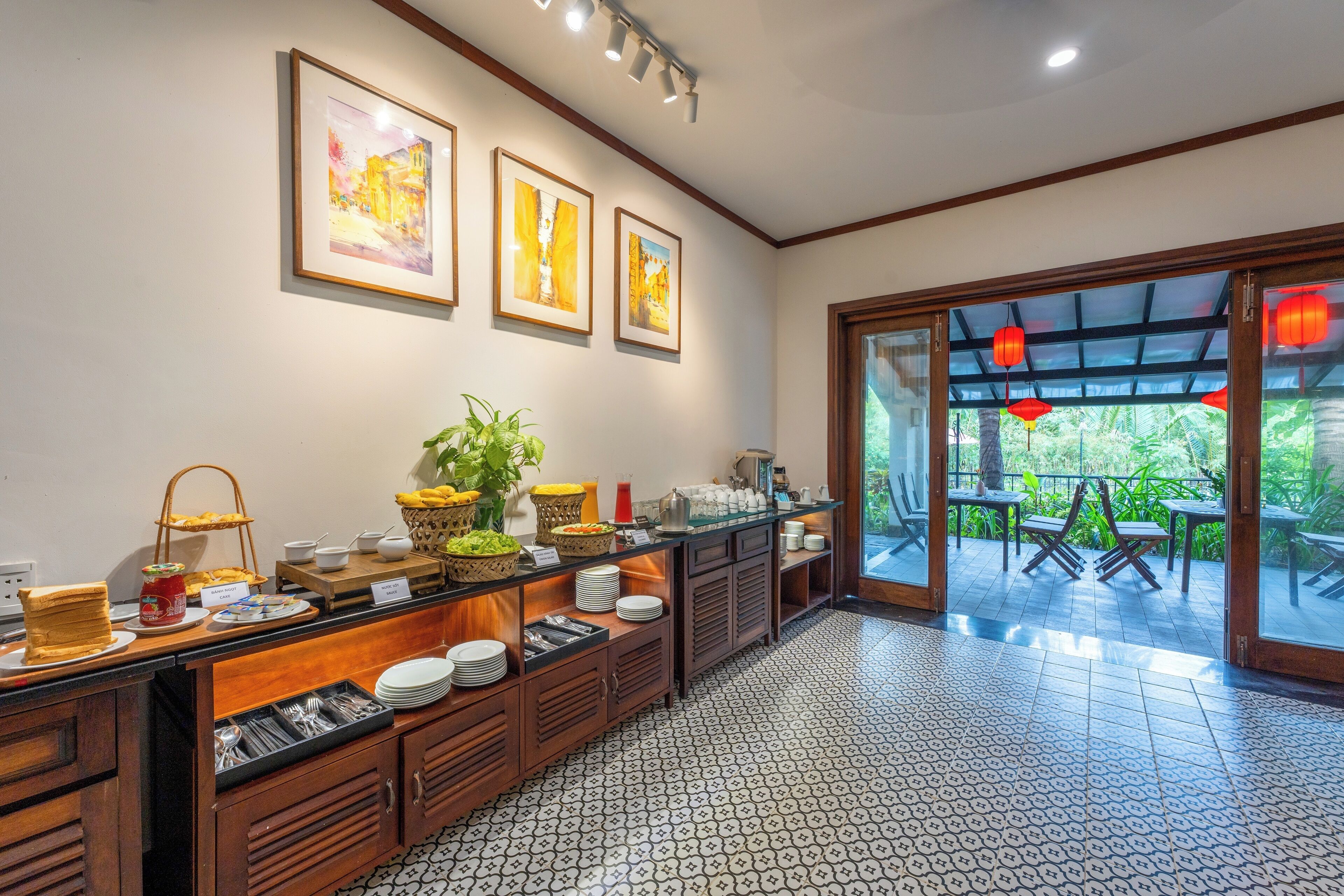 A buffet area with a variety of food items, a coffee station, and a seating area with tables and chairs.