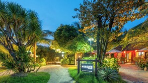 A well-lit pathway leading to a building with a sign reading "MAYCI".