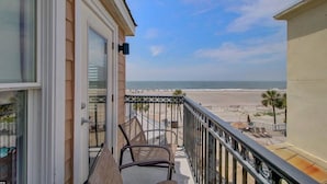 A balcony with wicker chairs overlooking a beach. - Steps to Two Oceanfront Pools | Walk to Dining | Grand Pavilion (Isle of Palms)