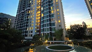 A high-rise building with multiple floors, likely a hotel or residential complex, with a clear sky in the background. - "La Gente", The People (rakyat) in Spanish, represents our dedication and passion to serve our guests and meet interesting souls. (Kuala Lumpur)