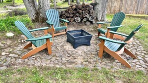 A seating area with Adirondack chairs and a fire pit. - Log Cabin located on the Greenbrier River in Hinton WV (Hinton)