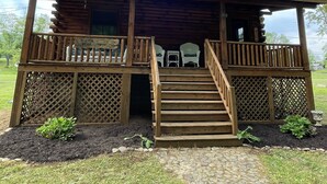 A wooden cabin with a porch, a staircase, and a sign reading "Hinton Head". - Log Cabin located on the Greenbrier River in Hinton WV (Hinton)
