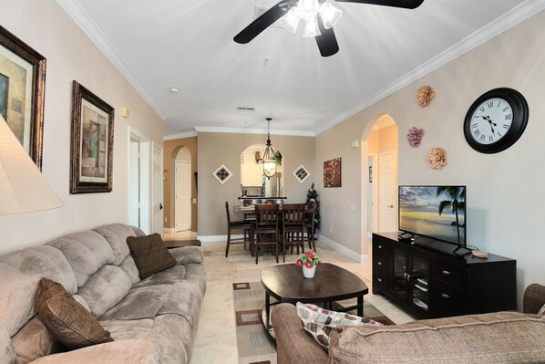 Relax in this inviting living space with a plush sofa, flat-screen TV, and dining area.
