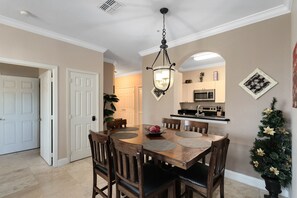 Enjoy meals in this stylish dining area with a wooden table and six comfortable chairs.