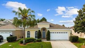 A residential house with a two-car garage, a well-maintained lawn, and a mailbox. - Last Minute Disney! Private Pool, Game Room & Themed Bedrooms. Book Now! #64097 (Orlando)