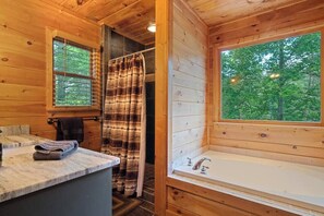 Bathtub, hair dryer, towels, shampoo