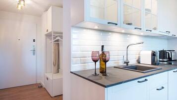 Fridge, stovetop, dishwasher, coffee/tea maker