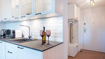 Fridge, stovetop, dishwasher, coffee/tea maker