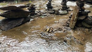 A wooden structure with a balcony, surrounded by a natural setting with a stream and rocks. - Retreat - Creek, Sliding Rock, Waterfalls, Fishing, Hiking, Hot Tub, Fire Pit (Old Fort)