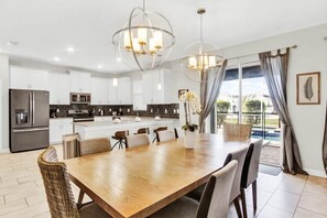 Enjoy meals in the kitchen with stainless steel appliances and a dining area with a table and chairs.
