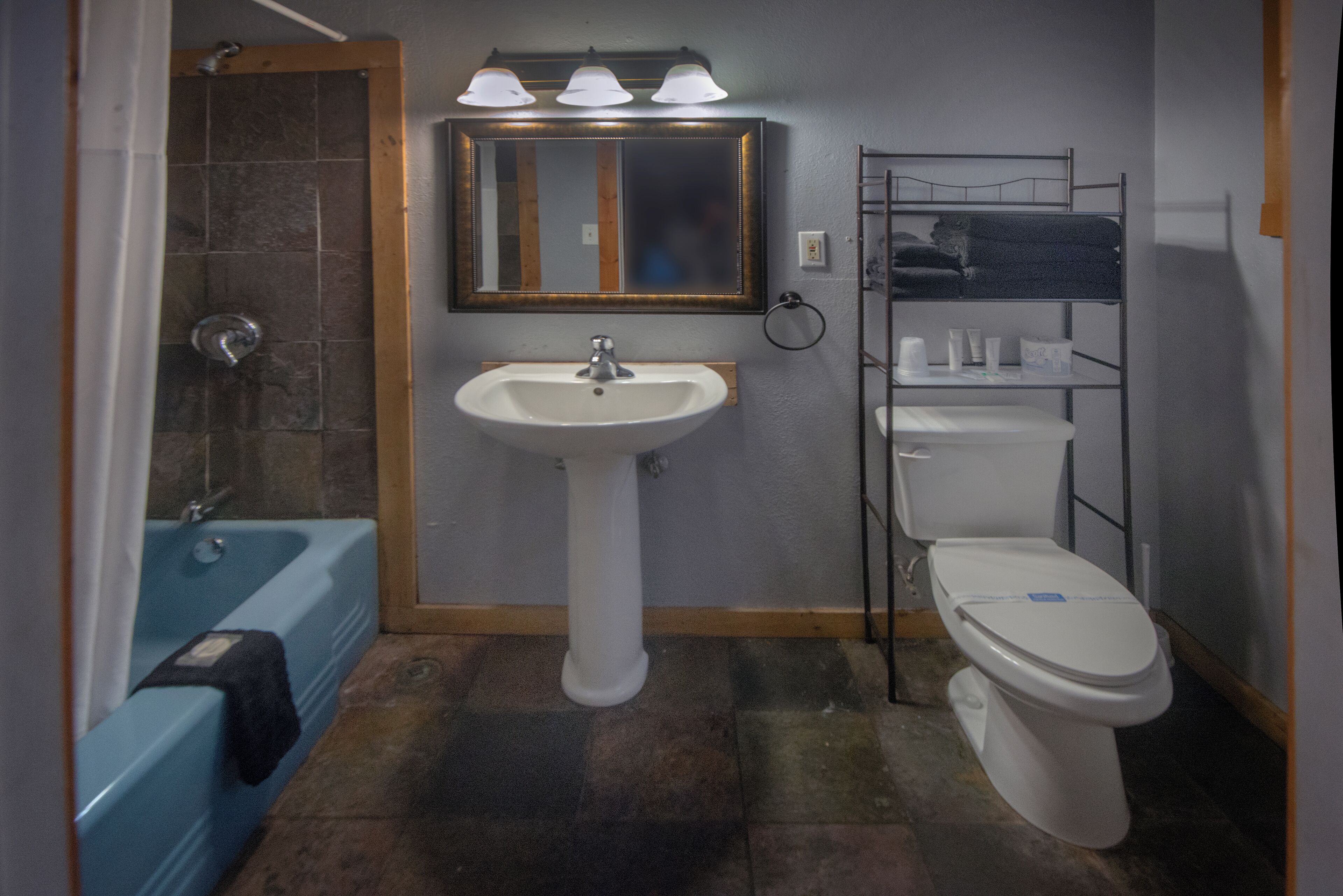A bathroom with a sink, toilet, and bathtub.